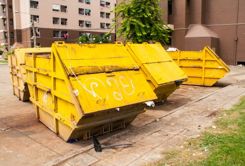 Mini skip container placed in a household driveway in Thamesmead